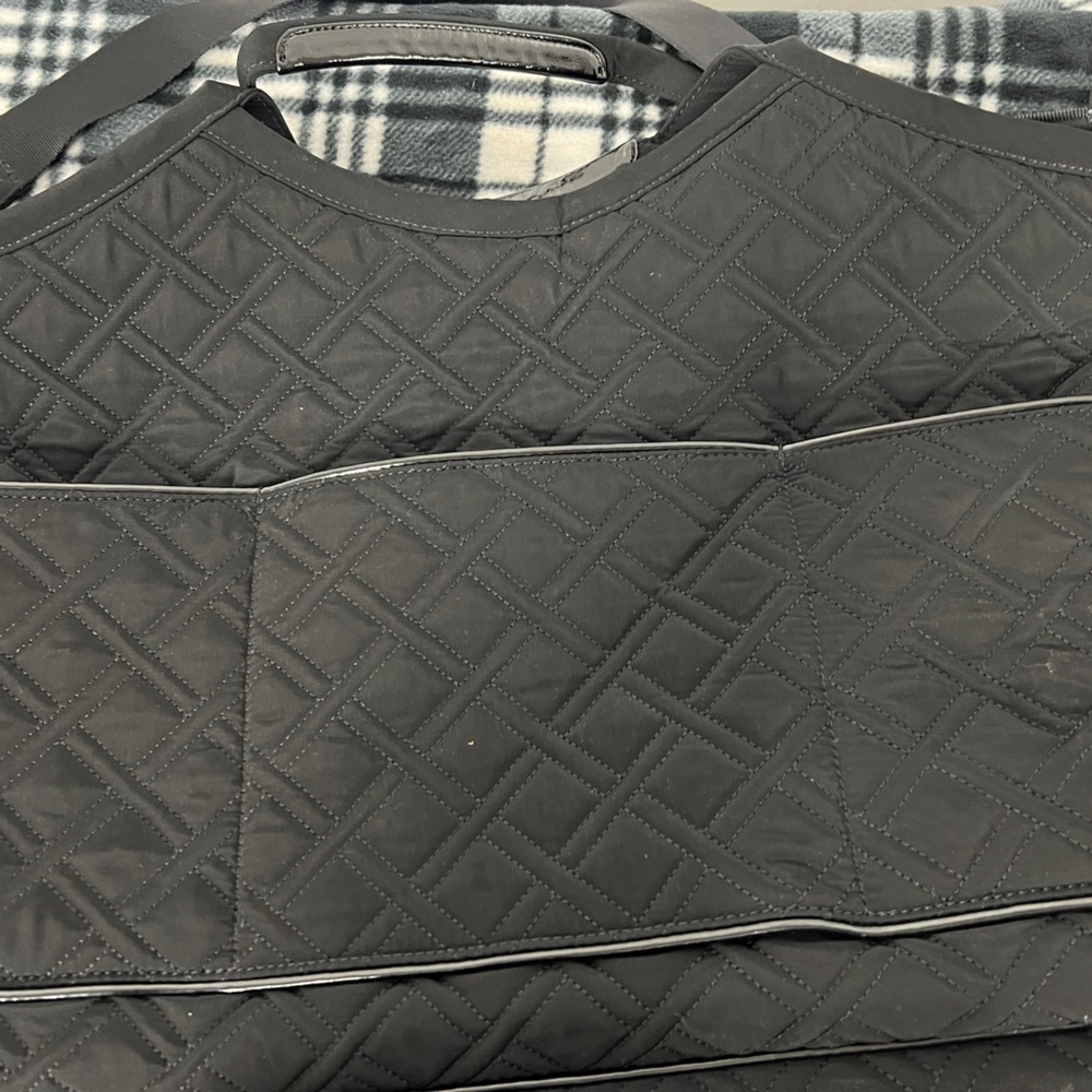 Large vera Bradley black quilted bag multiple inside and outside pockets.